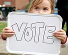 Little girl holding a vote sign
