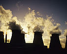 Cooling towers letting out steam and smoke at a coal-fired power station.